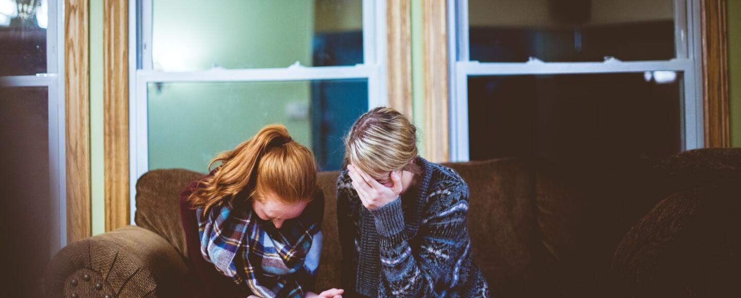 Pair of people consoling one another