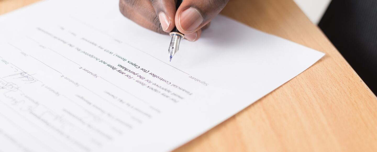 Someone signing a contract