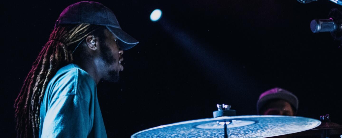 Drummer playing a drum kit onstage