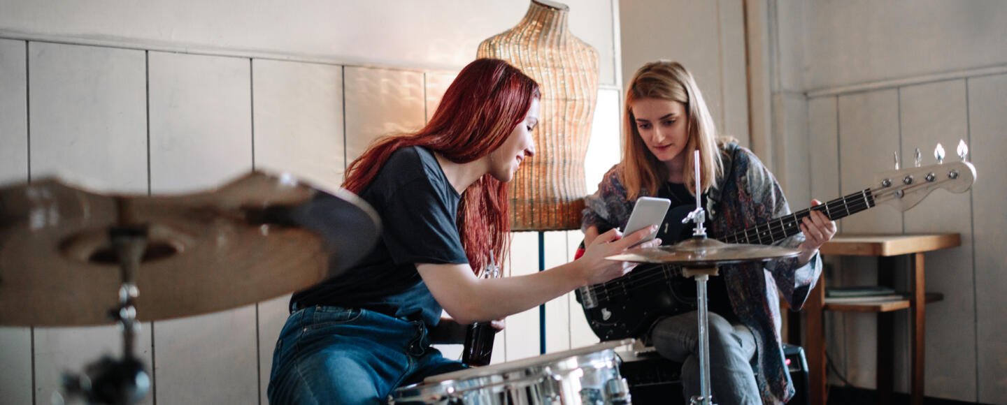 Two female musicians rehearsing and talking together