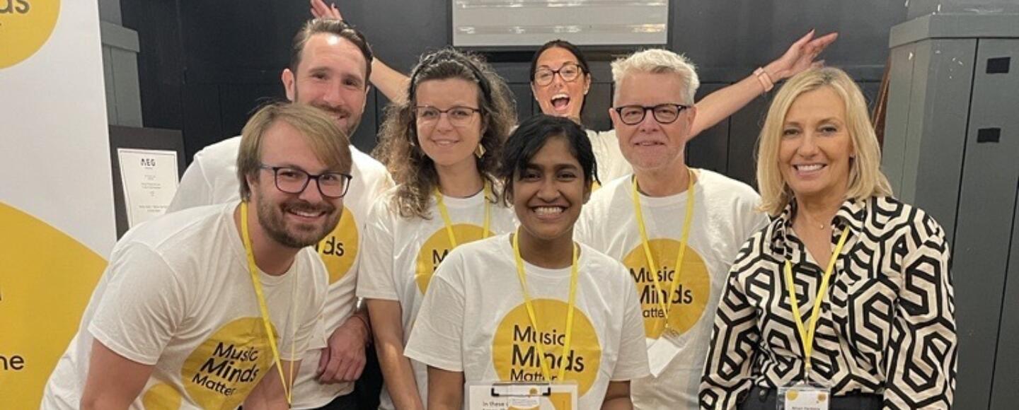 A group of volunteers wearing Help Musicians t shirts at an event