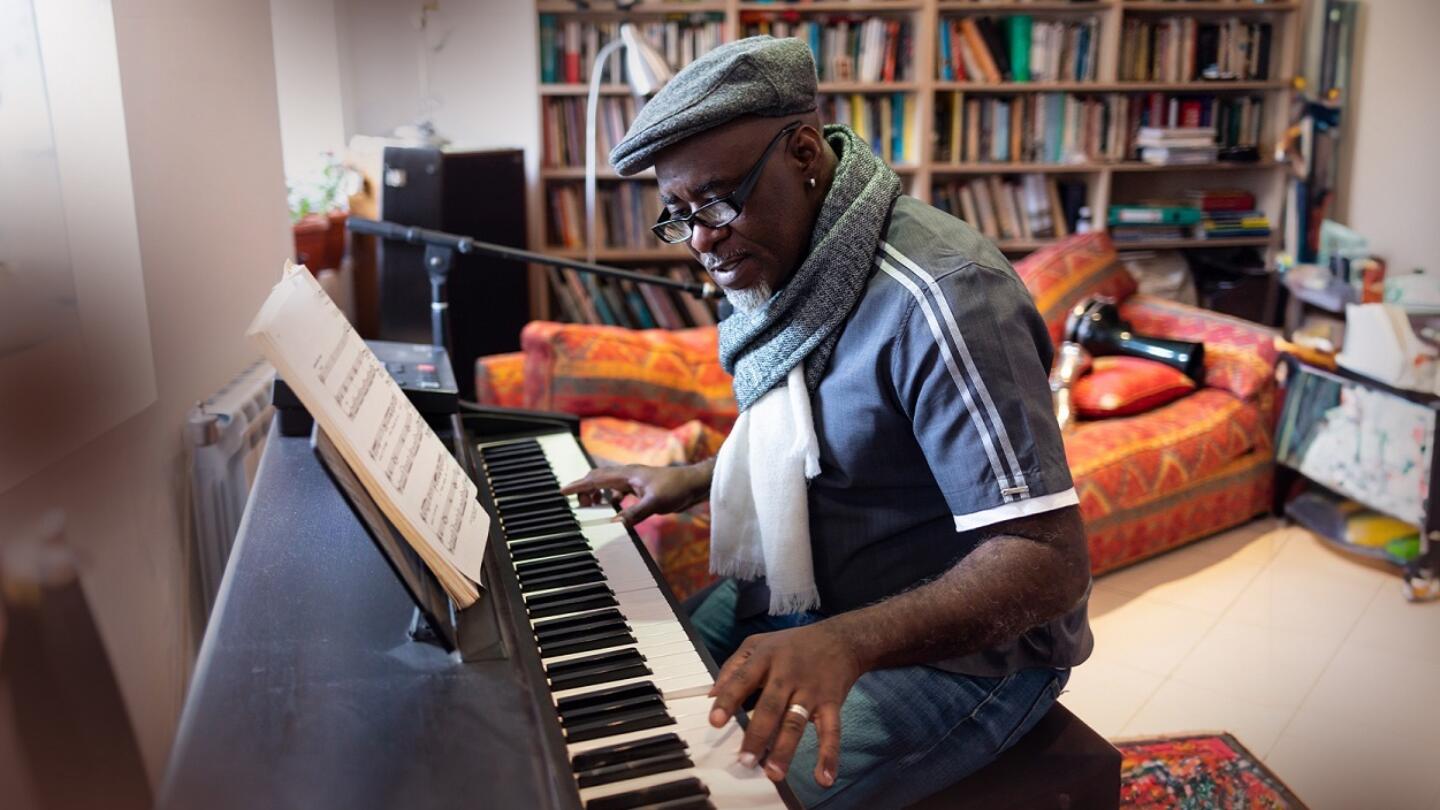 Musician sitting at a piano