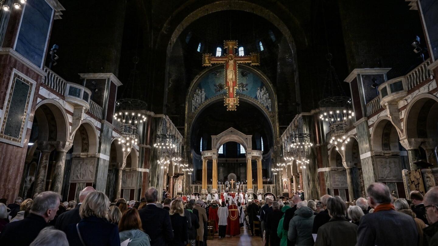 A congregation look toward the cathedral's alter