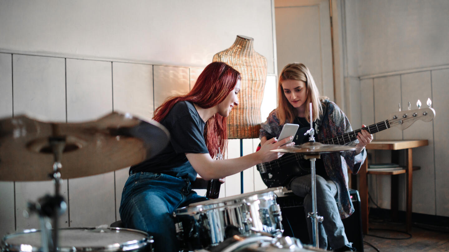 Two female musicians rehearsing and talking together