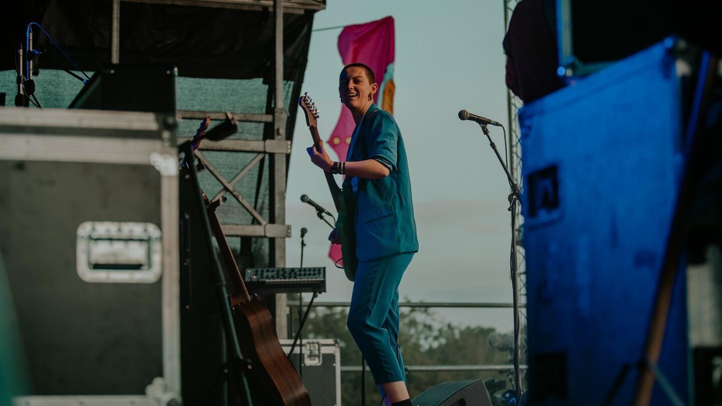 A musician on stage at a festival