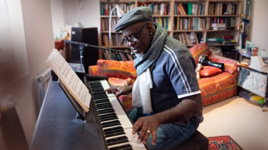 Musician sitting at a piano