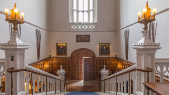 A entrance area of Lambeth Palace, showing a staircase with a blue rug leading to the upper floor.