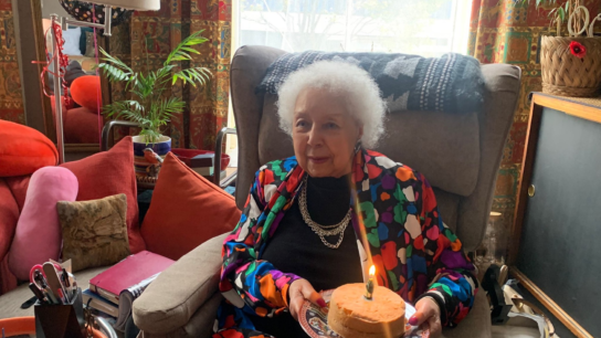 Lady holding a birthday cake