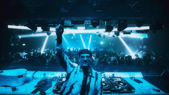 DJ waving his hand in a nightclub