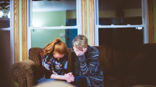 Pair of people consoling one another