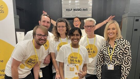A group of volunteers wearing Help Musicians t shirts at an event